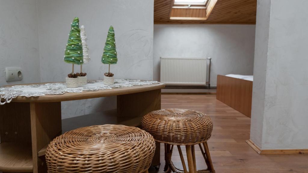 a room with a table and two stools with trees on it at Готель Меридіан in Yasinya