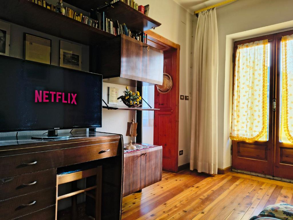 a kitchen with a tv on top of a dresser at Ciasa Cadorina - Relax nelle Dolomiti in Pelos