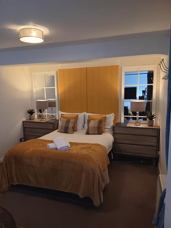 a bedroom with a large bed and a window at The Studio in Windermere