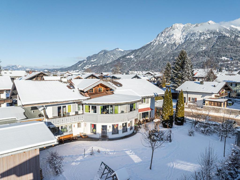 arial view of a town in the snow with mountains at Alma Hotel Oberstdorf in Oberstdorf