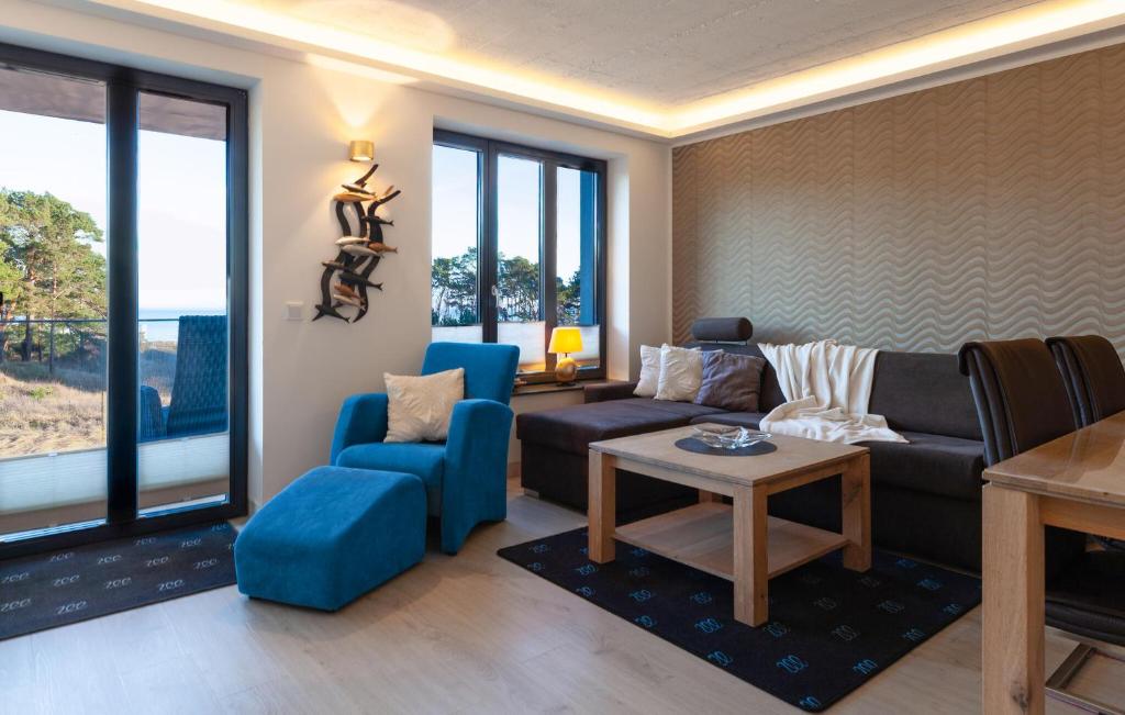a living room with a couch and chairs and a table at Eden in Binz