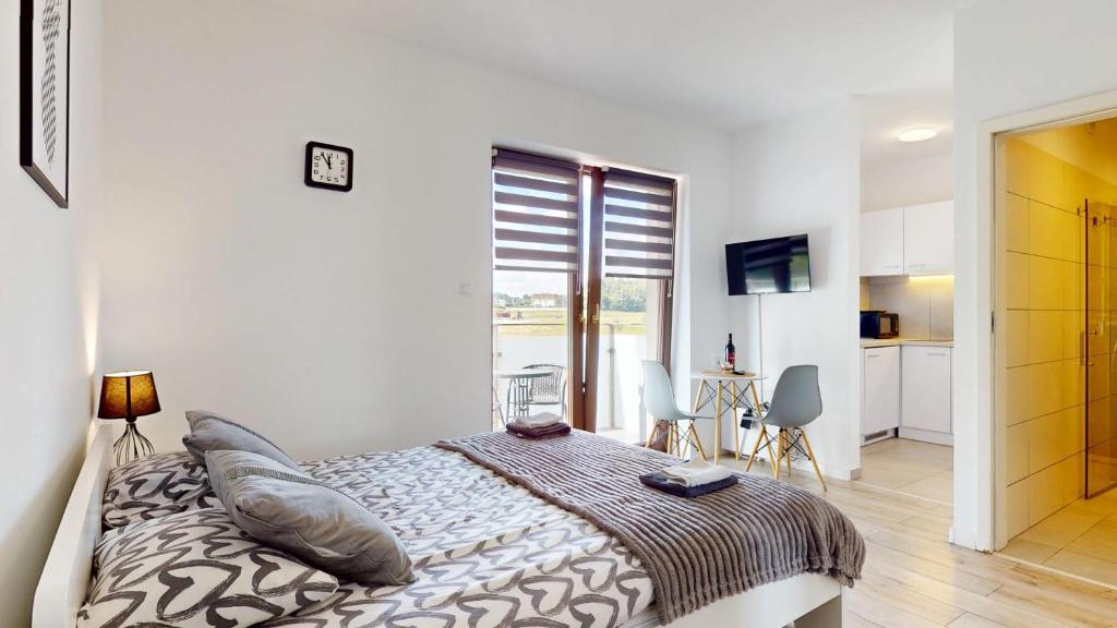 a bedroom with a bed in a room with a window at Studio Fibra Barista in Rybnik