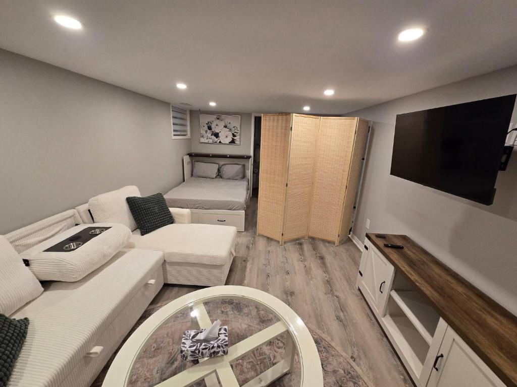 a small living room with a couch and a tv at Cozy East Hill 2026 in Belleville