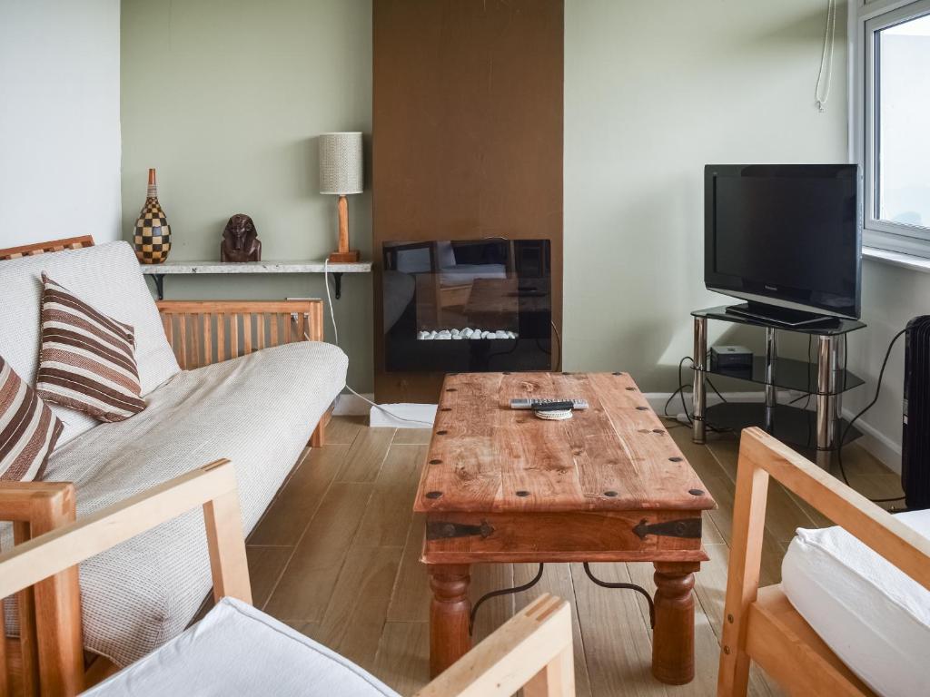 a living room with a couch and a coffee table at Eastcliff Bungalow in Mundesley