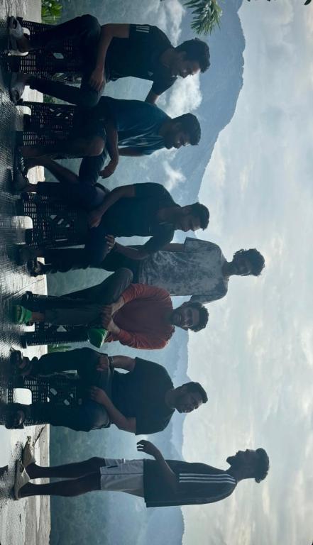 a group of men standing in the water at The EDGE Paradise in Neriyamangalam