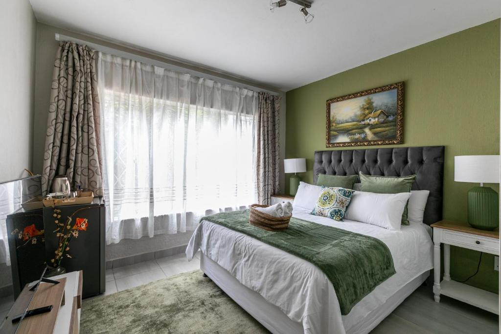 a bedroom with a large bed and a window at Mistica on St James in Johannesburg