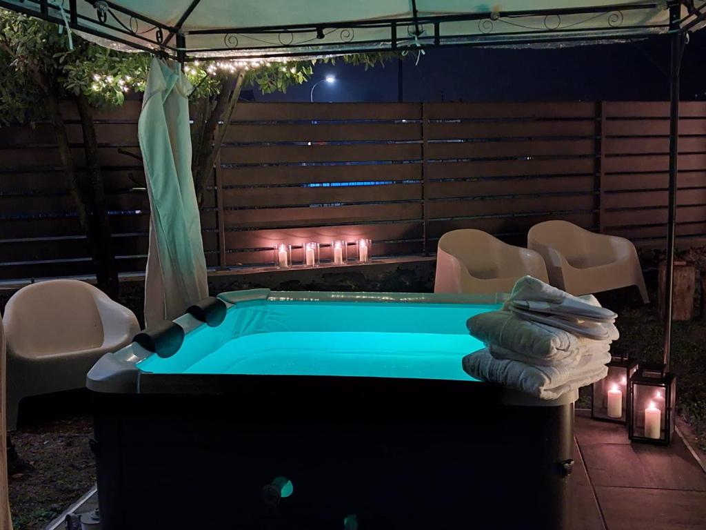 a pool table in a backyard with lights and chairs at AgliChalet Bosco-Vasca idromassaggio privata, condivisa tra i due chalet, con parcheggio privato gratuito e colonnina ricarica auto veloce con supplemento in Domodossola