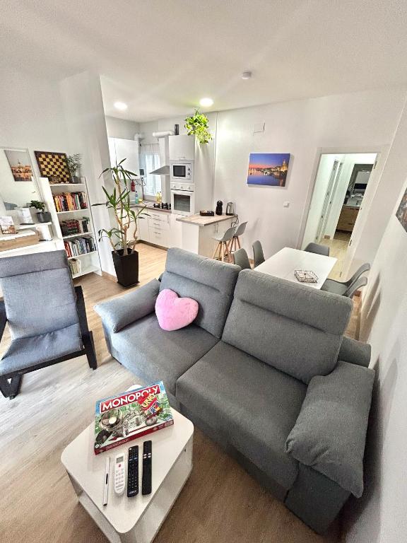 a living room with a couch and a table at Apartalux Sevilla Camas in Camas