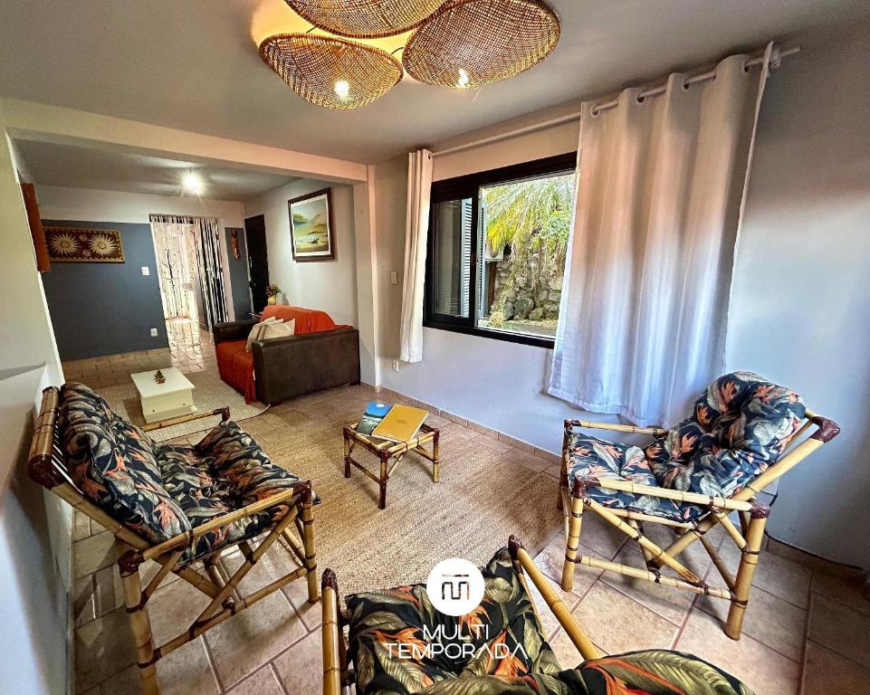 a living room with two couches and a window at Canto das Praias - Florianópolis/SC in Florianópolis