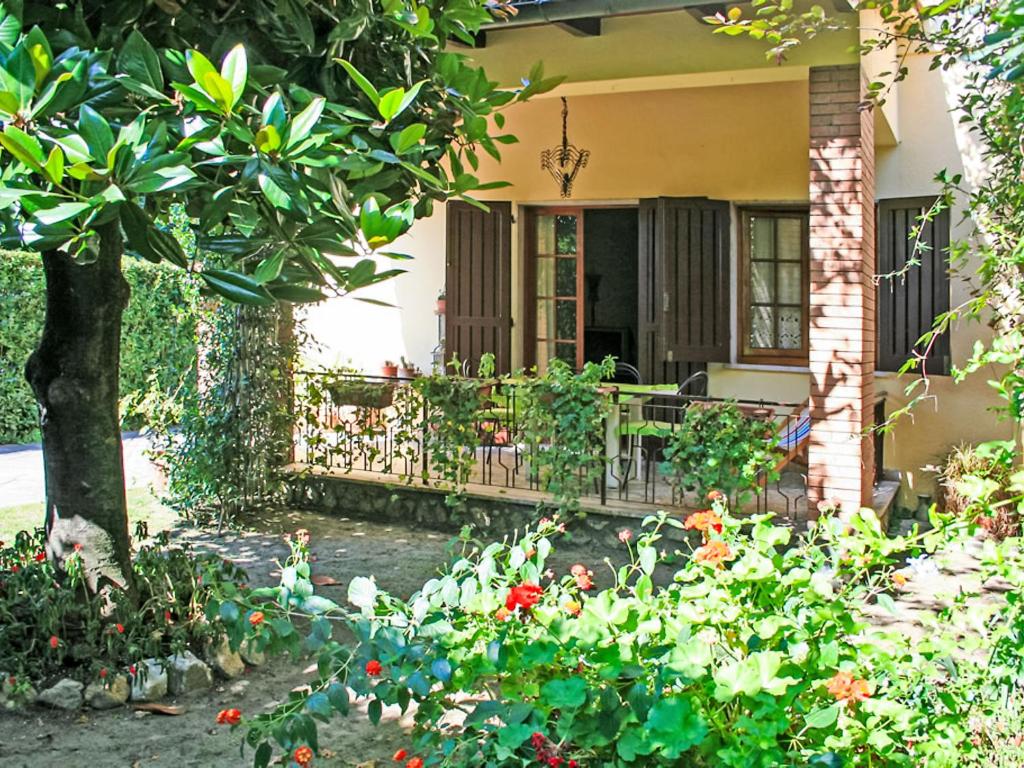 a house with a porch and flowers in front of it at Villa Patrizia by Interhome in Forte dei Marmi