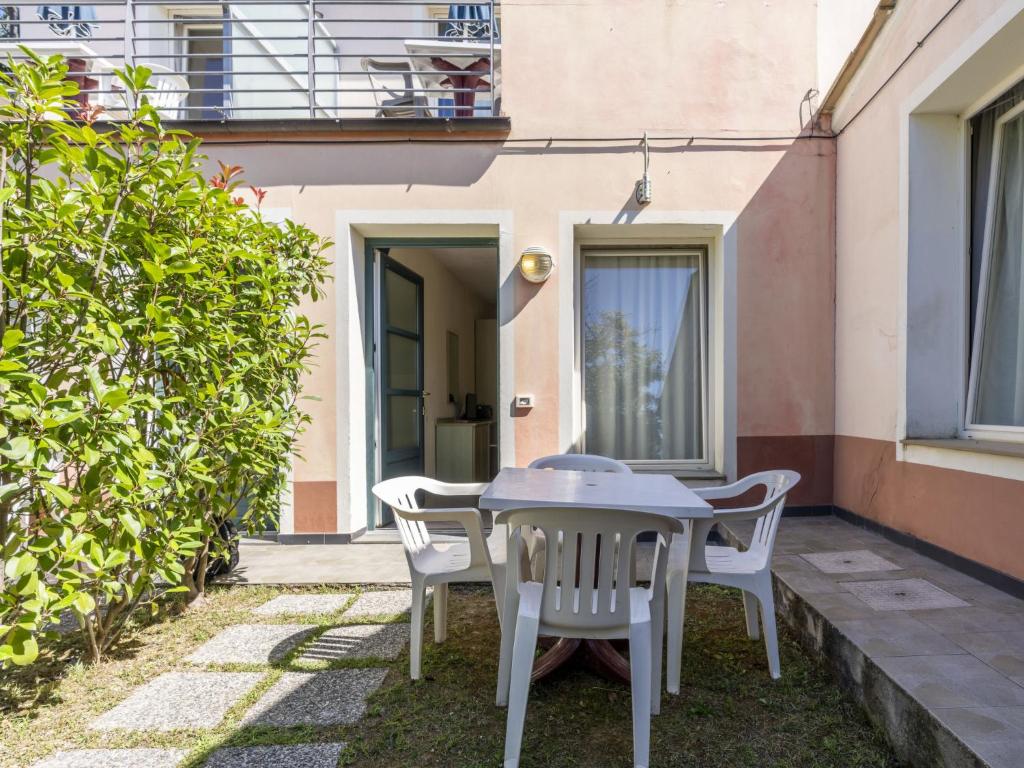 a patio with a table and chairs in front of a building at Studio Borgoverde-12 by Interhome in Imperia