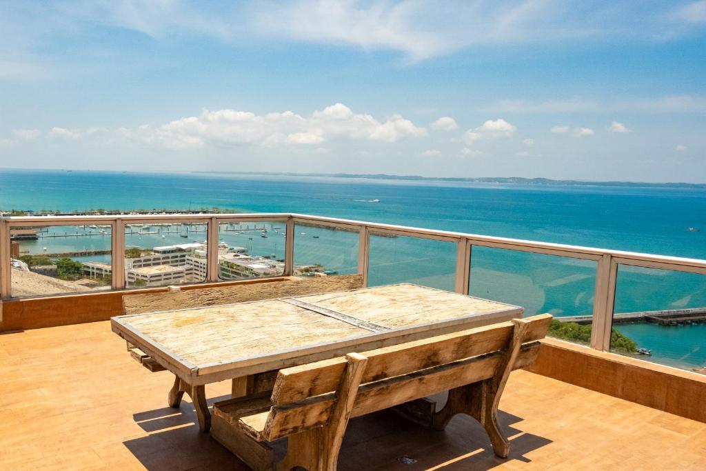 a table on a balcony with a view of the ocean at Pousada Colonial Chile in Salvador