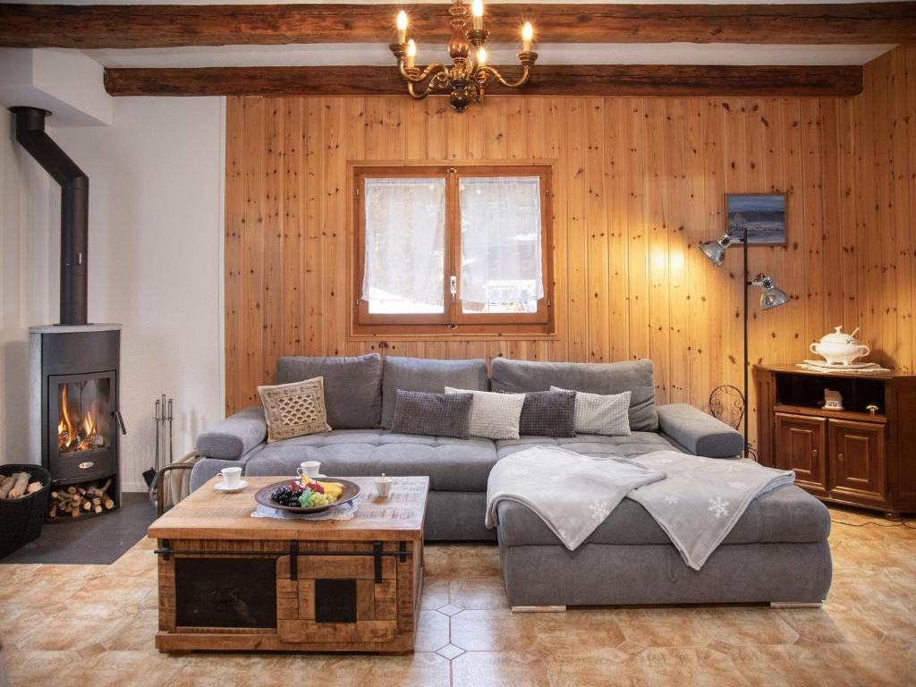 a living room with a couch and a fireplace at Chalet Mélèze 1967 by Interhome in Ovronnaz