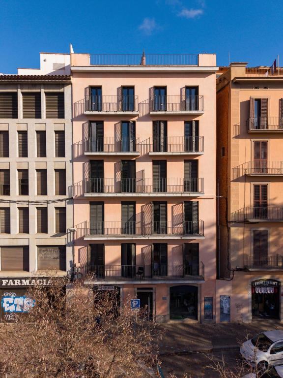 a tall building with balconies on the side of it at Modern apartments in one building, in the heart of Girona in Girona