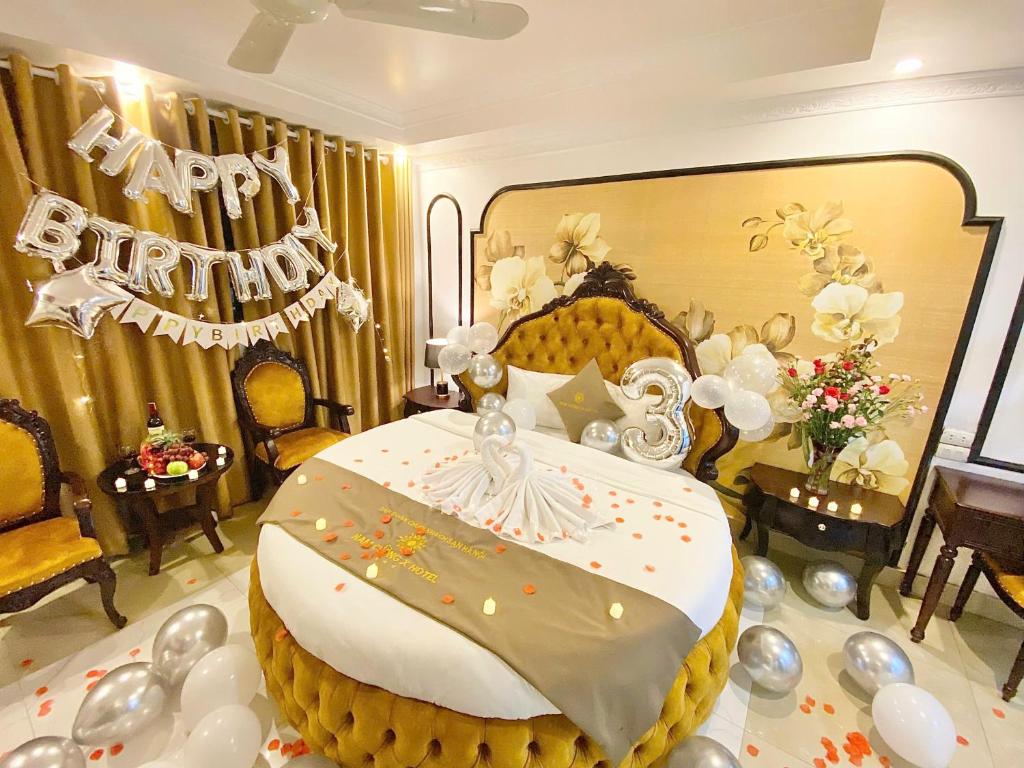 a birthday cake sitting on a table in a room at Nam Cường X Hotel in Hanoi