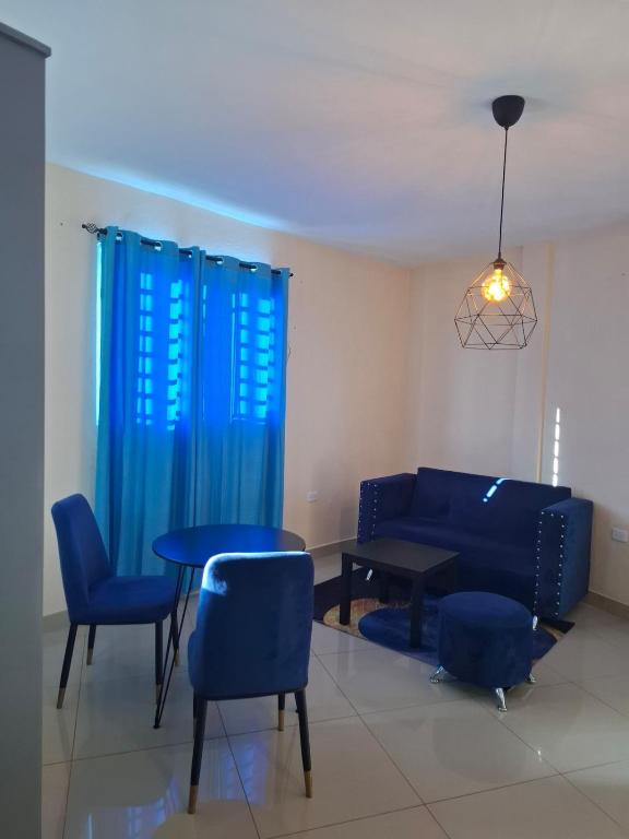 a living room with a couch and a table and chairs at Doña Minda Home in Naiboa