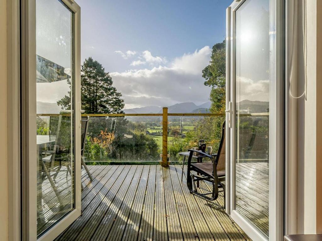 a balcony with a bench and a view of the mountains at 3 Bed in Keswick oc-90266 in Applethwaite