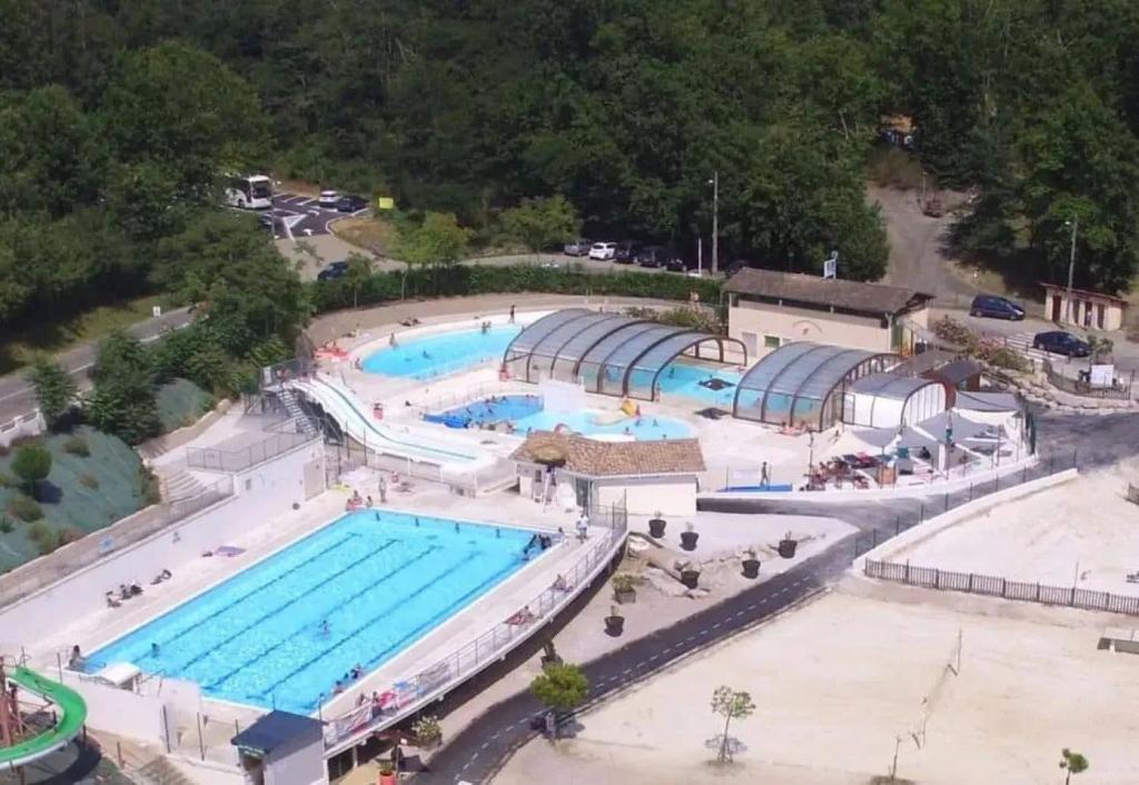 an overhead view of a large swimming pool at ZEcamping 3 étoiles dog friendly avec piscine couverte et chauffée in Monclar-de-Quercy