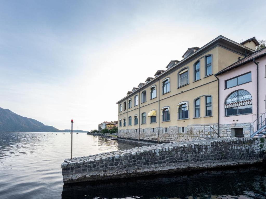 a building next to a body of water at Apartment Blu Lake by Interhome in Ghiffa
