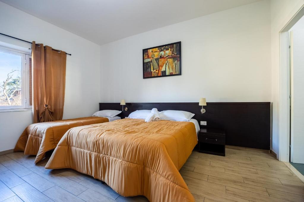 a hotel room with two beds and a window at I Tigli in Valmontone