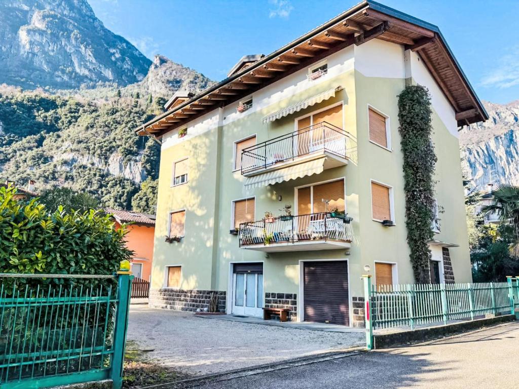a house with a balcony and mountains in the background at Apartment Ca dei Noni by Interhome in Riva del Garda