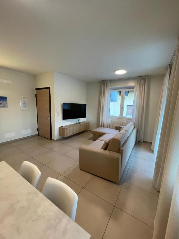 a living room with a couch and a flat screen tv at Manzoni in Esine