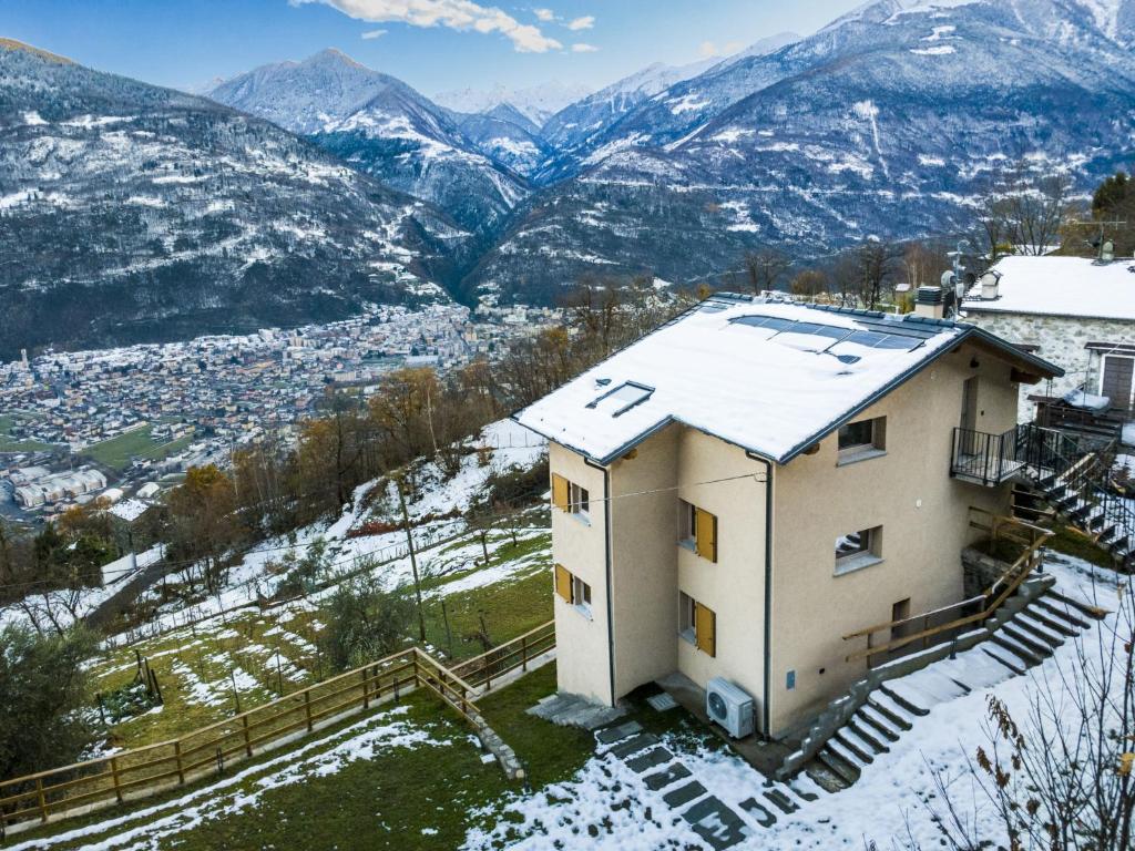 a house in the snow with mountains in the background at Villa Cech Coast House by Interhome in Civo