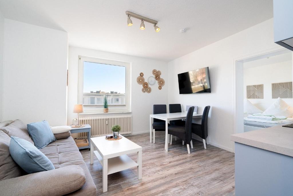 a living room with a couch and a table at Solymar Whg 64 in Grömitz