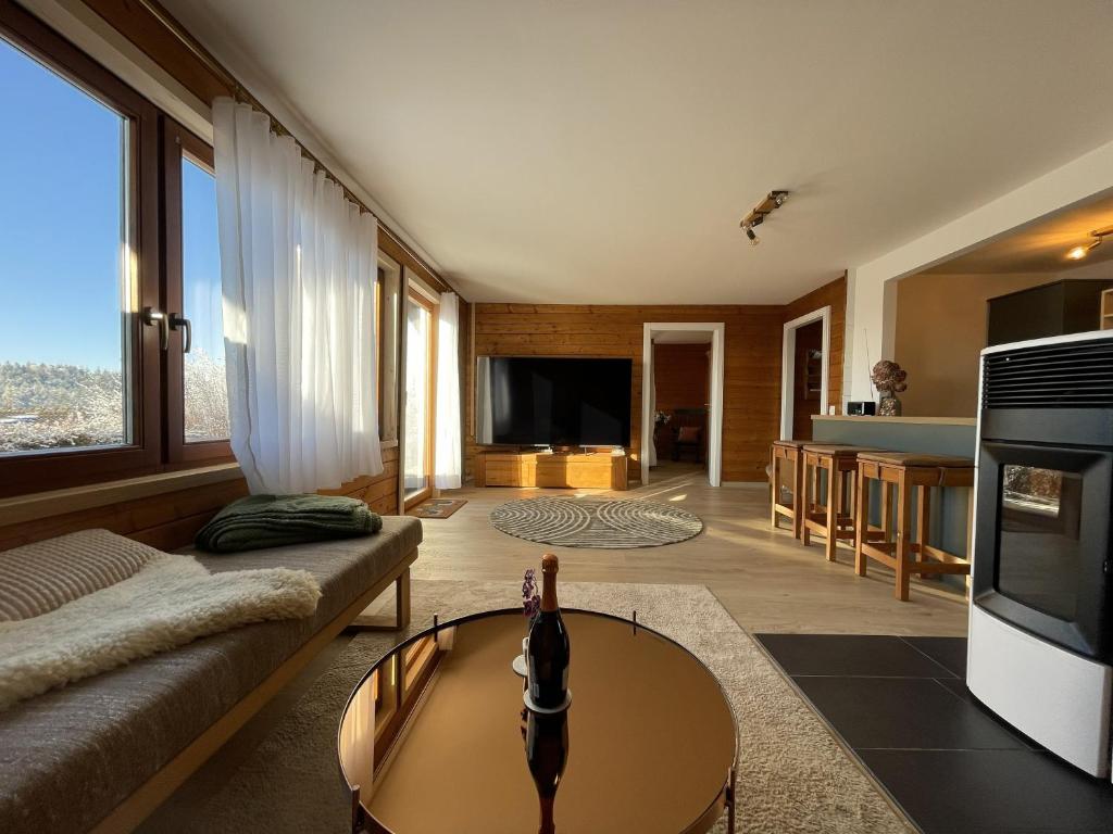 a living room with a couch and a table at Waldmarie in Grafenau