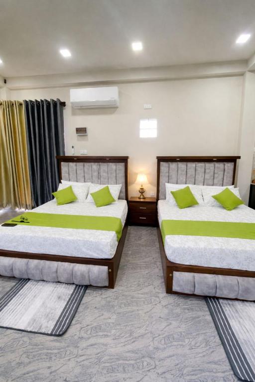 two beds sitting next to each other in a room at Horizon in Katunayaka