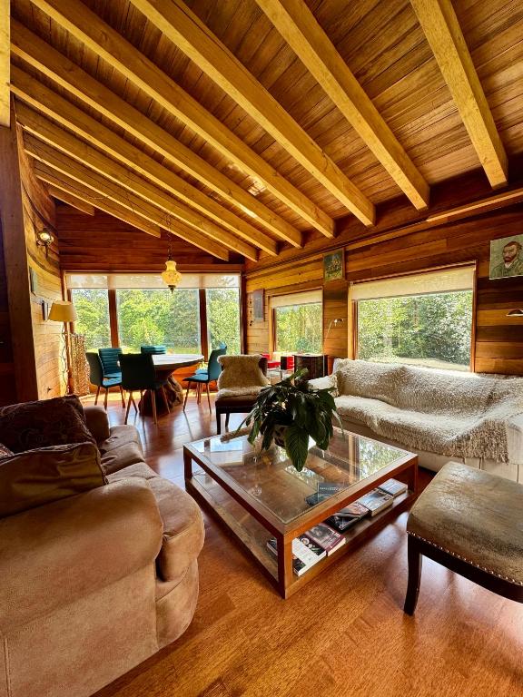 a living room with a couch and a coffee table at Casa Arrayan in Puerto Varas