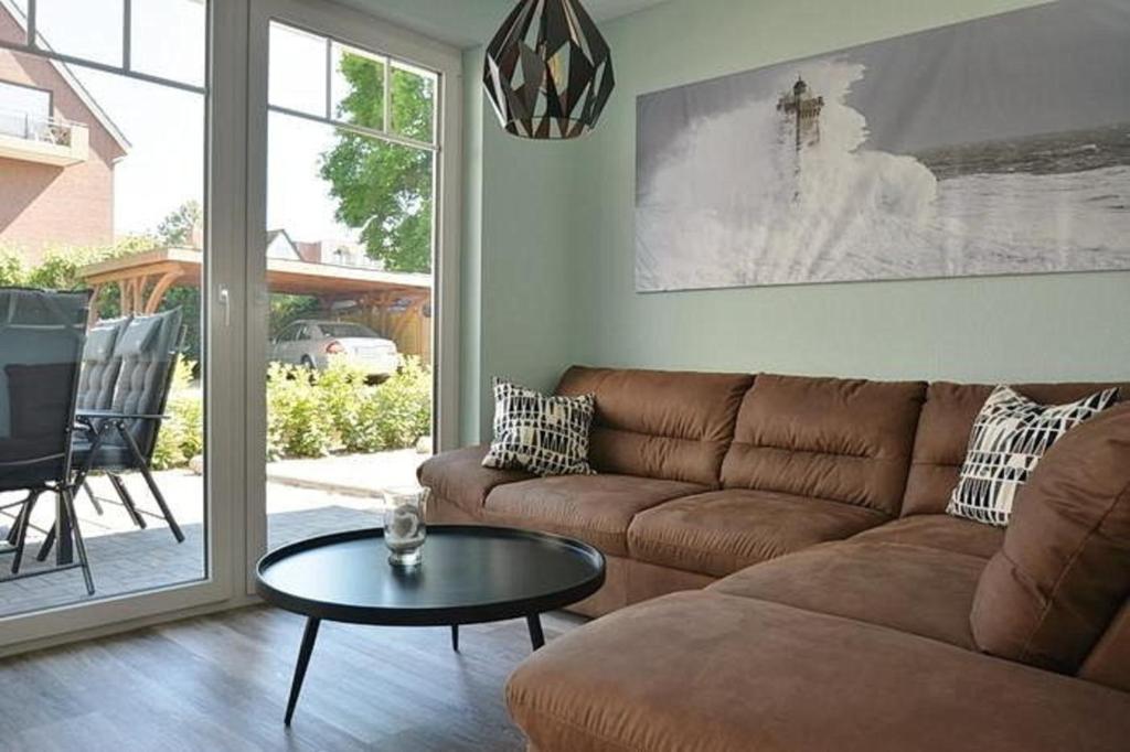 a living room with a couch and a table at Haus Fischerstraße 6a in Grömitz