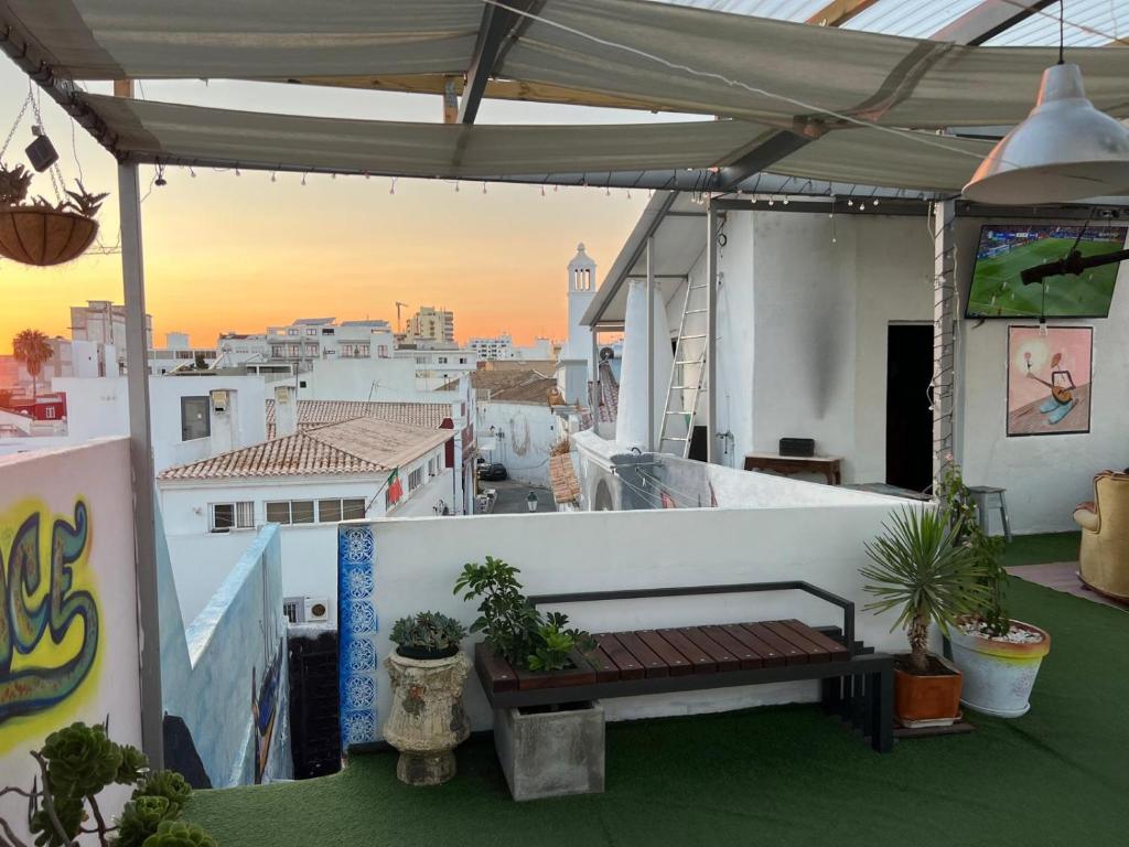 a balcony with a bench on top of a building at RIA Terrace in Faro