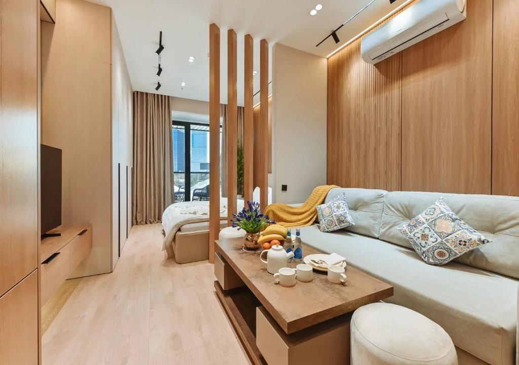 a living room with a couch and a table at Modern Spaces U-Tower in Tashkent