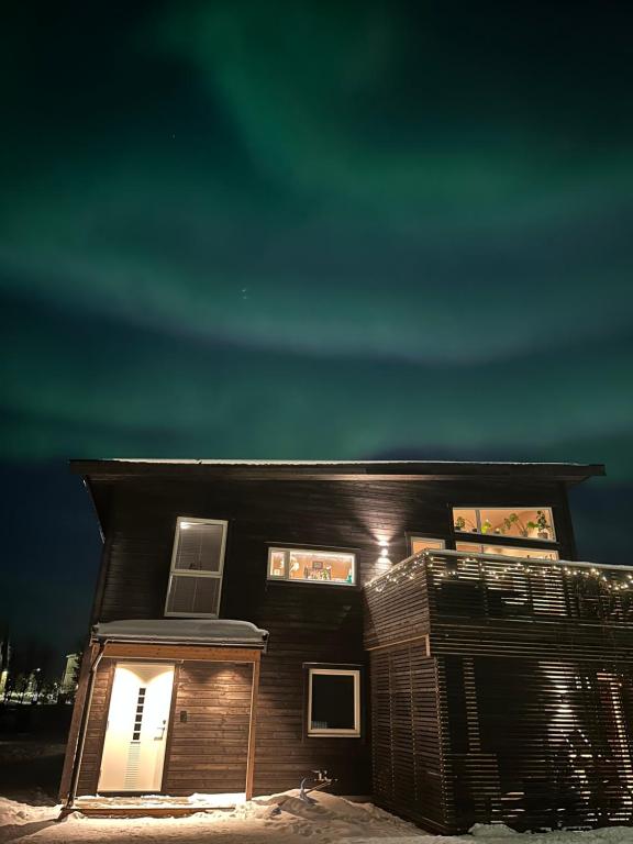 a house with lights on the front of it at night at Central apartment from 2025 in Alta