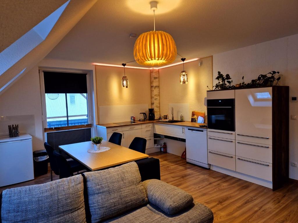 a kitchen with a table and a dining room at Ferienwohnung Sunny 2 in Mittenwalde