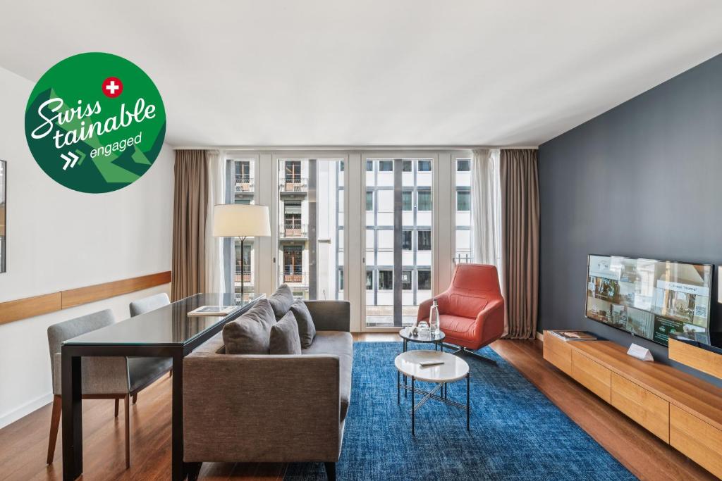 a living room with a couch and a table at Fraser Suites Geneva - Serviced Apartments in Geneva