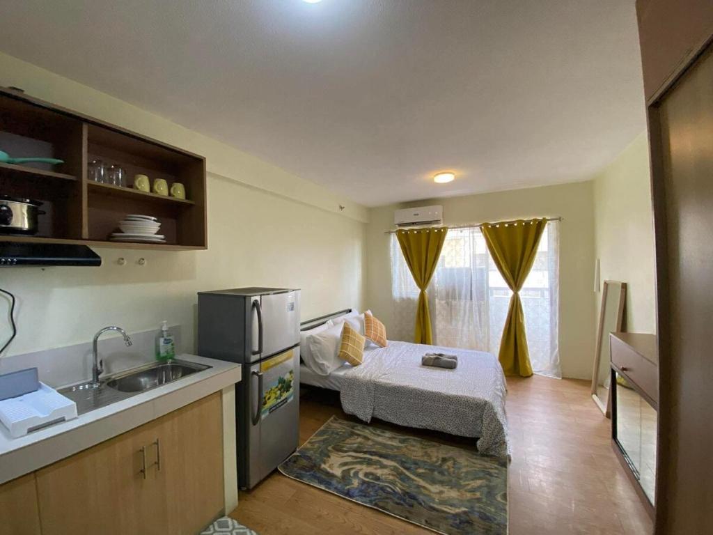 a small kitchen with a bed and a sink at Chic Studio near Ocean Park in Cebu City