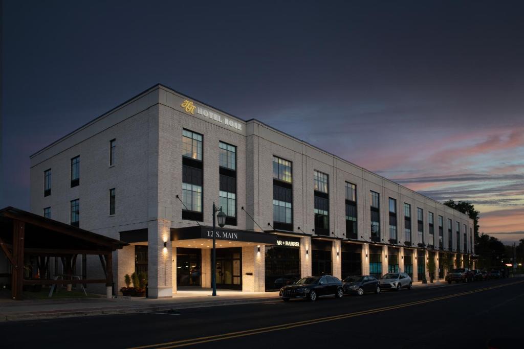 a large building with cars parked in front of it at Hotel Rose in Rockford