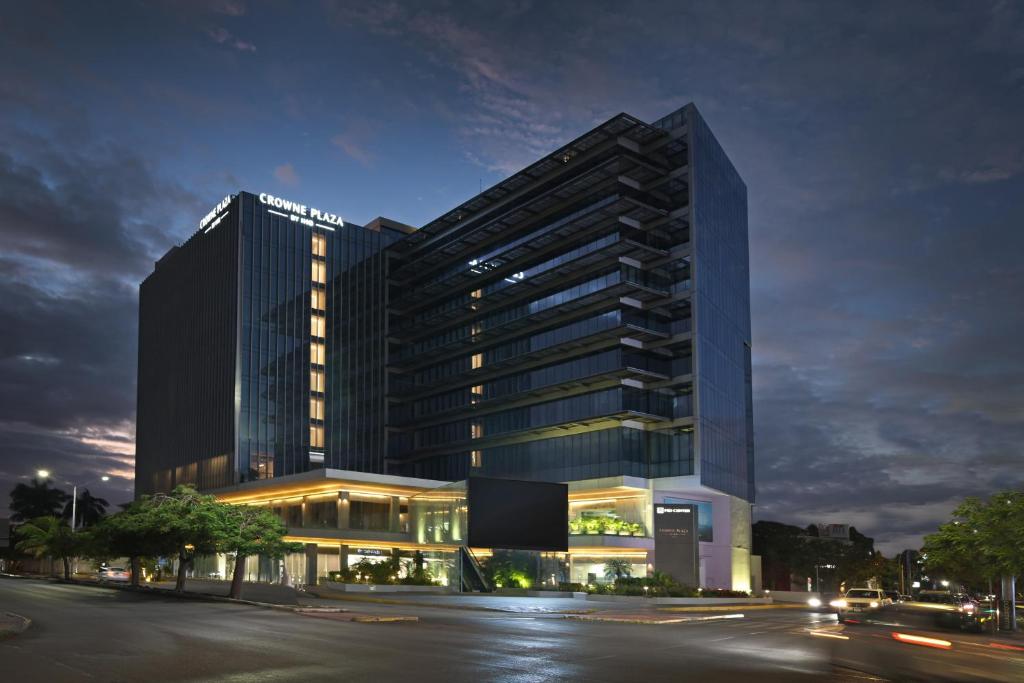 a tall building with a street in front of it at Crowne Plaza Merida by IHG in Mérida