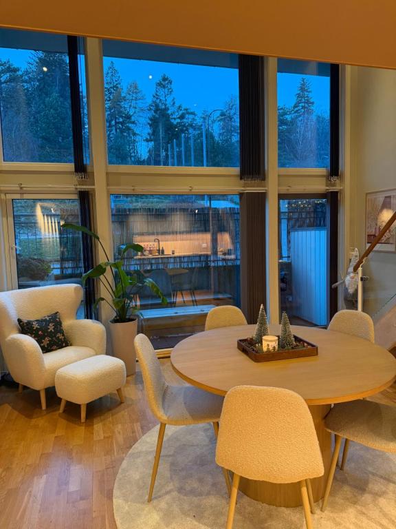 a room with a table and chairs and a large window at Leilighet i Kristiansand in Kristiansand