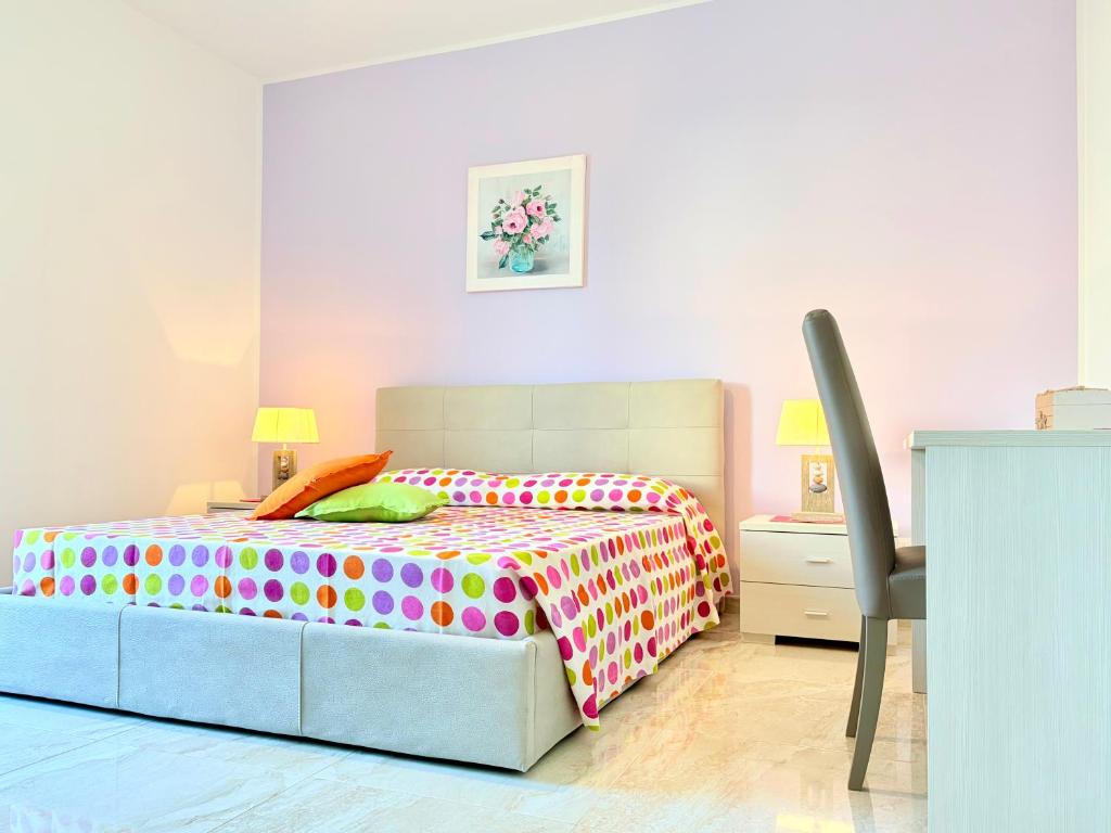 a bedroom with a bed with a polka dot bedspread at Casa Zoe in Gallipoli