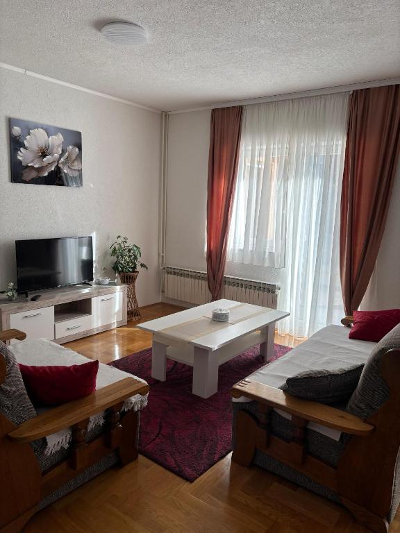 a living room with a couch and a table at APARTMAN Iva in Tomislavgrad