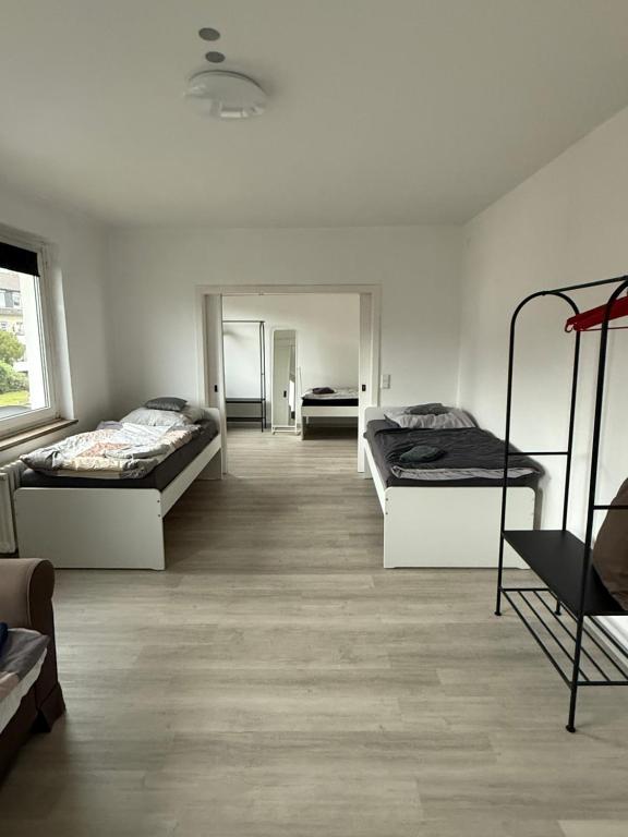 a room with two beds and a mirror at 3-Zimmer Ferienunterkunft in Bad Salzuflen