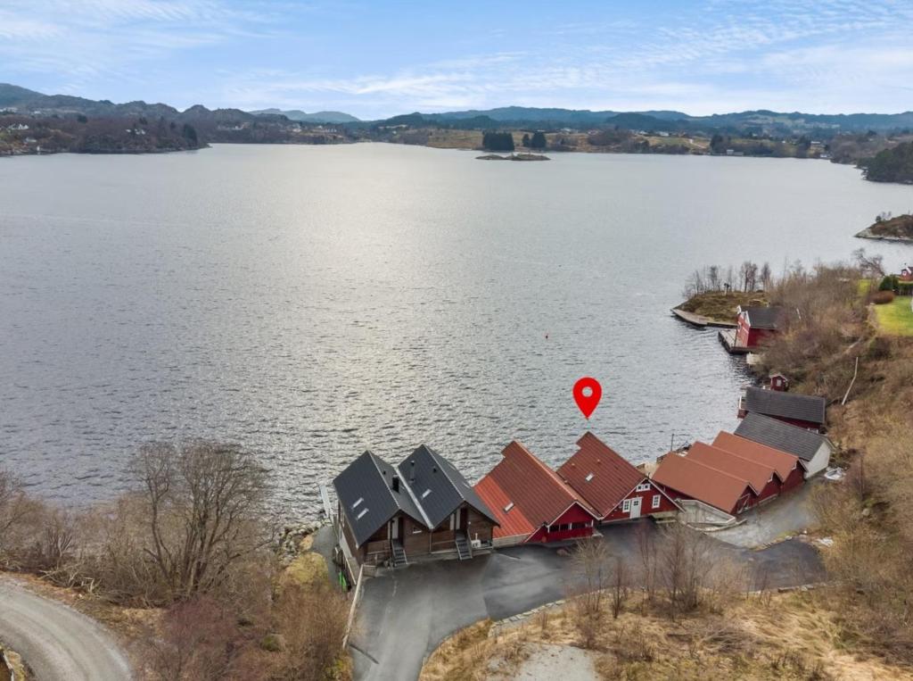 an aerial view of a lake with houses and a red heart at Cabin by the lake in Sveio