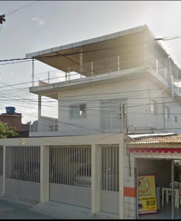 a white building with a balcony on top of it at Bonito é ser Feliz Budget in Recife