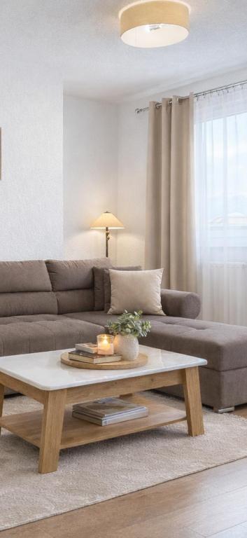 a living room with a couch and a coffee table at Apartmani Sun & Moon in Žepče