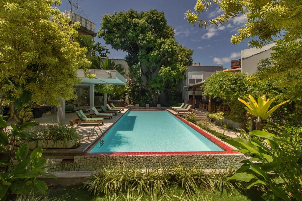 a swimming pool in the backyard of a house at Villa dos Graffitis Pousada in Morro de São Paulo