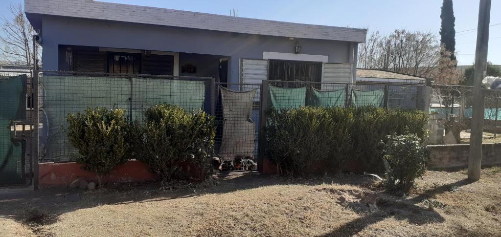 a house with a fence and plants in front of it at Latido de Montaña in Bialet Massé