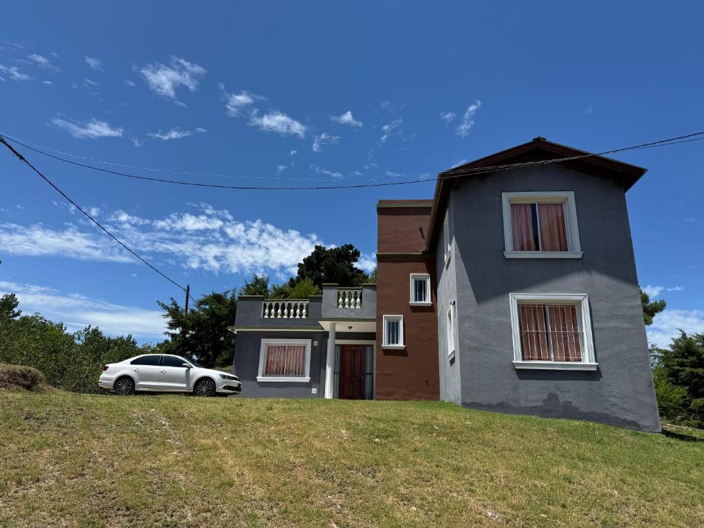 a house on a hill with a car in front at Casa cairo in Ostende